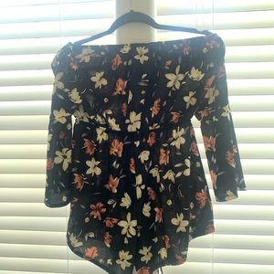 Romper with off the shoulder long sleeves.